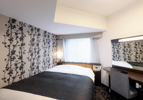 新瀉的住宿－APA Hotel & Resort Niigata Ekimae Odori，酒店客房设有床和窗户。