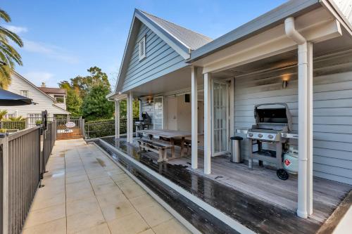 a patio with a grill on a house at Sandy Jandal - 3-5 Bedroom - Russell Cottages in Russell