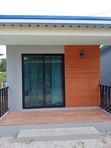 a house with a large window on the side of it at KOOK BUNGALOW in Koh Mook
