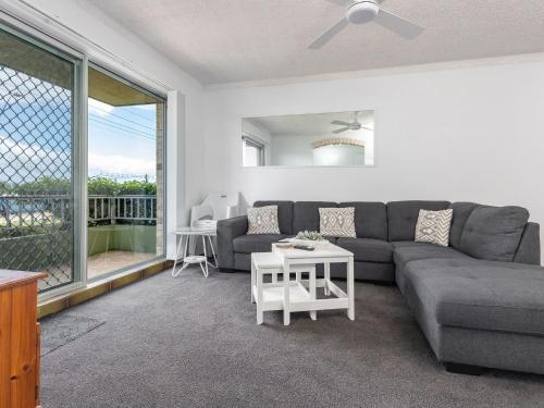 a living room with a couch and a table at Camelot 01 in Forster