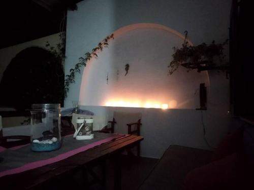 a dark room with a table with a jar on it at Ananias House in Karianí