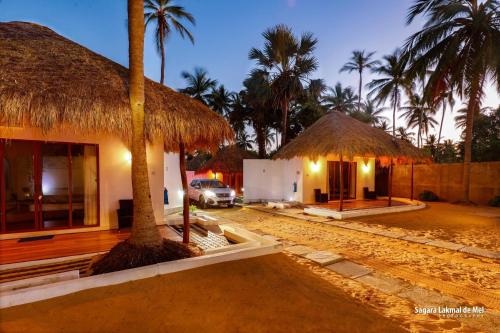 a resort with a car parked in front of a building at The Blue Lagoon Resort Kalpitiya in Kalpitiya