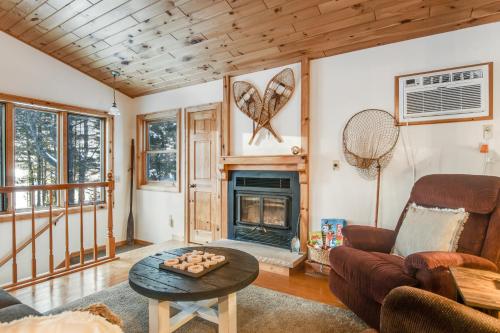 a living room with a couch and a fireplace at Cabin on the Loop-Upper in Three Lakes