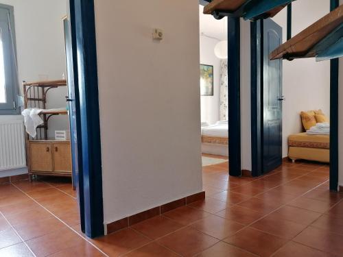 a living room with a tile floor and a mirror at Ananias House in Karianí