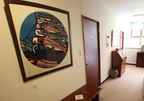 a large painting on the wall of a hallway at Gableview Forest Inn ゲーブルビュー in Nikko