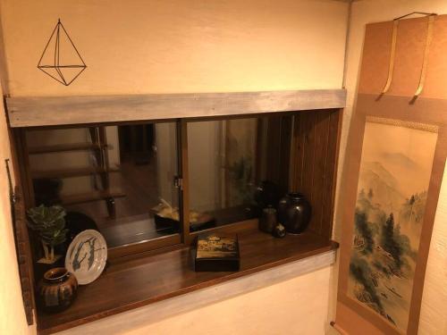 a window with a clock and a book on it at Riders Ridge Luxury Chalet sleeps 12 Ski In Ski Out Myoko in Akakura