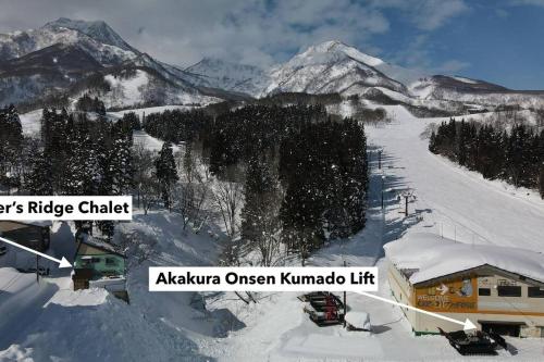 a snow covered ski slope with a ski lift at Riders Ridge Luxury Chalet sleeps 12 Ski In Ski Out Myoko in Akakura