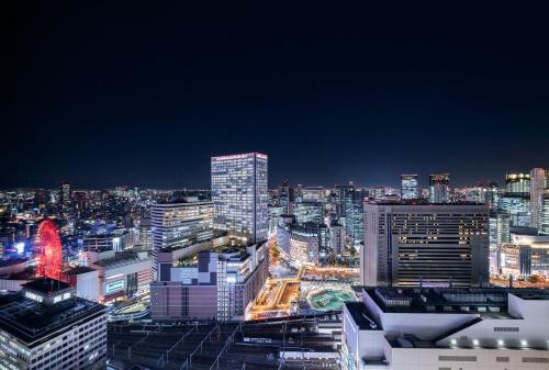 a view of a city skyline at night at Hotel Hankyu RESPIRE OSAKA in Osaka