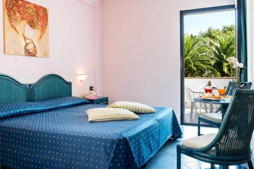 Ένα ή περισσότερα κρεβάτια σε δωμάτιο στο Villaggio Giardini D'Oriente