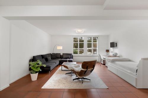 a living room with a couch and a table at Cozy Boutique Apartment at Mt. Rigi in Goldau