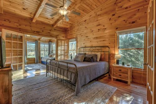 a bedroom with a bed in a log cabin at Love You Deerly in Morganton