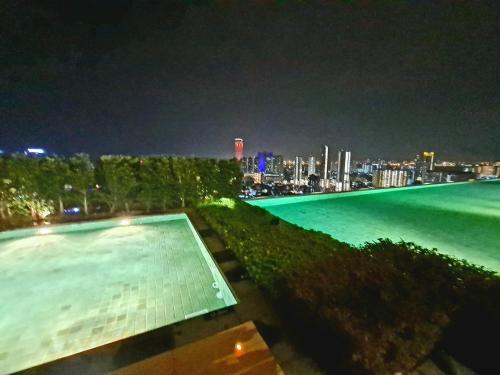 a swimming pool with a city skyline at night at Beacon Executive Suites in George Town