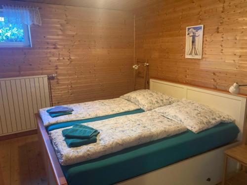 a bedroom with two beds with towels on them at Sport- und Seminarhaus Walsertal in Thüringerberg