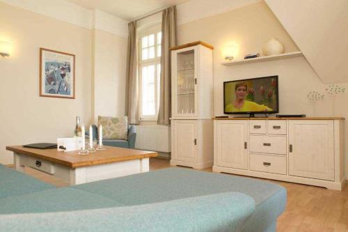 a bedroom with a bed and a tv in it at Villa Dora App 10 in Bansin