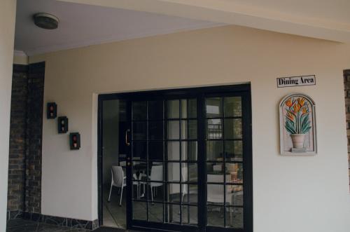 a room with a door with a potted plant on the wall at Towers Lodge in Boksburg