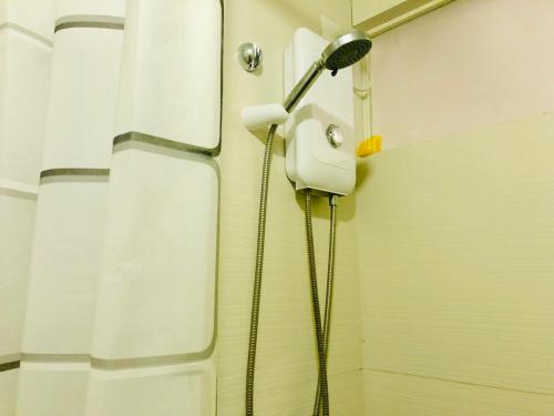 a shower in a bathroom with a shower head at The Sentinel Residences in Manila