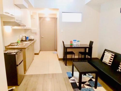 a living room with a kitchen and a dining room at The Sentinel Residences in Manila