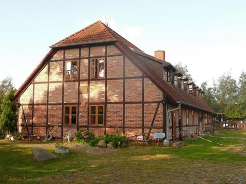 a large wooden house in a field of grass at Ruegen Fewo 106 in Wiek auf Rügen 