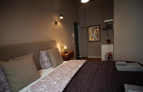 a bedroom with a bed and a mirror on the wall at Luxury Suites Meir by Rikas Hotels in Antwerp