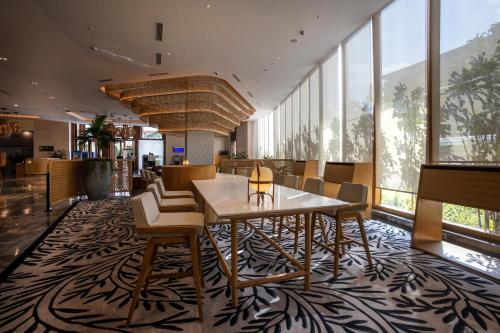 a dining room with a table and chairs at Novotel Hyderabad Airport in Hyderabad