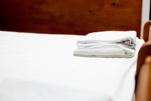 a stack of towels sitting on a bed at Casa Zâna Bună in Gherla