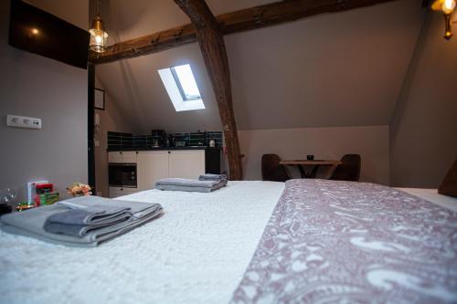 a bedroom with a bed with towels on it at Luxury Suites Meir by Rikas Hotels in Antwerp