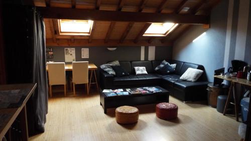 a living room with a couch and a table at Chambre d'Hôtes Barnabas in Saint-Martin-de-la-Porte