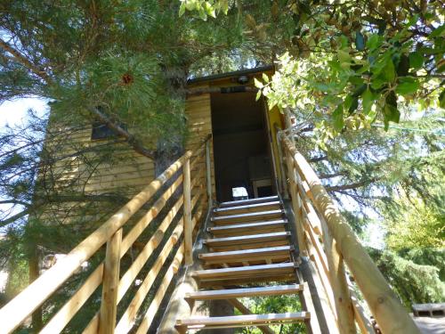 a staircase leading up to a tree house at CABANE perchée dans les arbres in Robion en Luberon