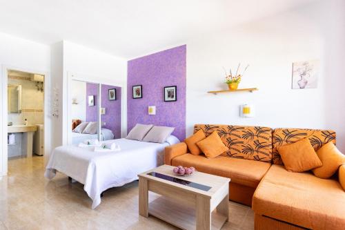 a living room with a couch and a table at Adeje Paraíso in Adeje