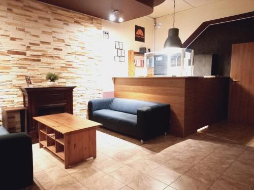 a living room with a couch and a table at Hostel Orange in Toruń
