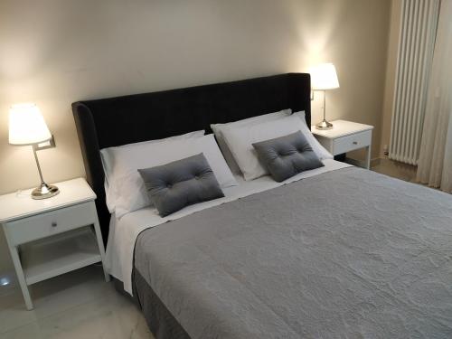 a bedroom with a large bed with two pillows on it at Sotto le Mura in Messina