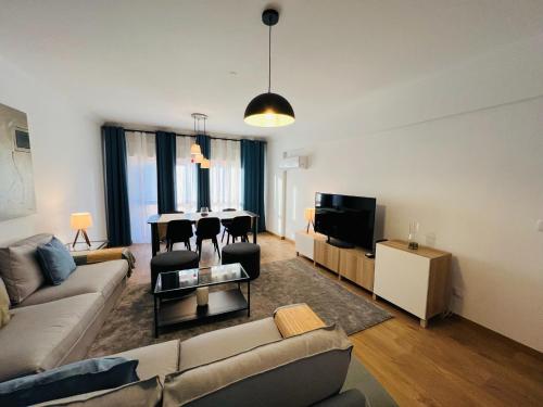 a living room with a couch and a table at Beautiful Apartment - Family and Group of Friends in Póvoa de Santa Iria