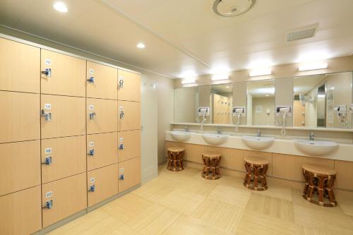a bathroom with two sinks and a row of mirrors at Meimon Taiyo Ferry 1st sailing from Kitakyushu to Osaka in Kitakyushu