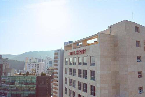 a building with a hotel nexus sign on top of it at Kenny Stay Busan Gijang in Busan