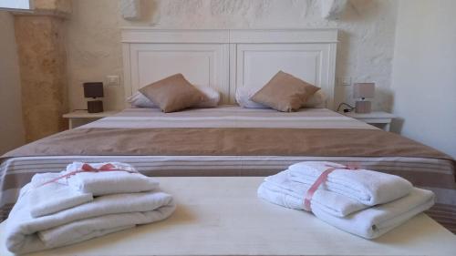 a bedroom with two towels sitting on a bed at MASSERIA SCALEDDA in Manduria