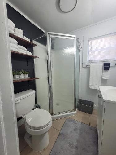 a bathroom with a toilet and a glass shower at TWO BEDROOM HOME IN BEAUTIFUL DOWNTOWN LAKELAND in Lakeland