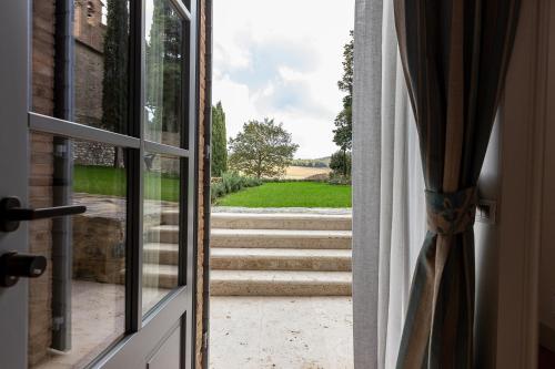 an open door with a view of some stairs at Tenuta CastelGiocondo in Montalcino
