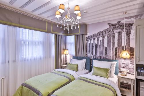 a bedroom with two beds and a chandelier at 9 Doors Hotel in Istanbul