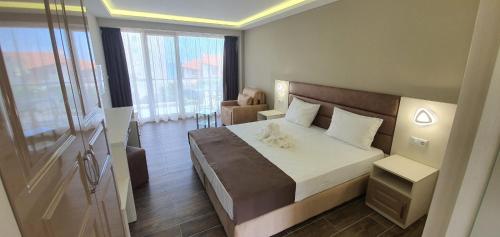 a bedroom with a large bed in a room at Hotel Sunny in Sozopol