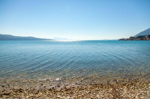 a large body of water with a rocky beach at Ligia Waterfront Apartments in Lygia