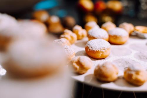 a tray of donuts with powdered sugar on them at Hotel Astoria in De Haan