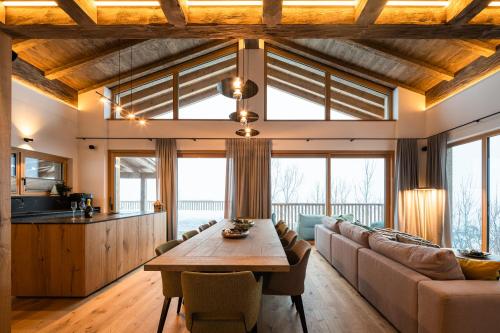a living room with a table and a couch at Das Chalet. in Mühlbach am Hochkönig