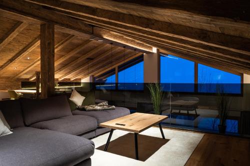 a living room with a couch and a table at Das Chalet. in Mühlbach am Hochkönig