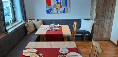 a dining room with a table with a red table cloth at Gästehaus Huber in Mittersill