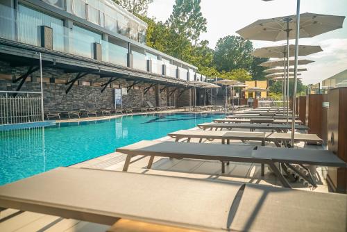 a row of tables and umbrellas next to a swimming pool at Atik Hotel in Unye