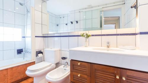 a bathroom with a toilet and a sink and a mirror at 1Sarri - Llafranc in Llafranc