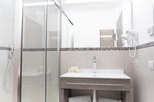 a bathroom with a sink and a shower at SALUS Locazione Turistica in Verona