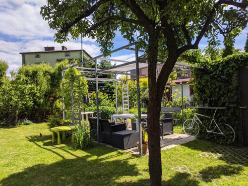 a garden with a table and chairs and a tree at APARTAMENT 16 in Zamość