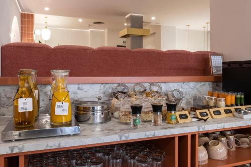 a counter with bottles of oil and glasses on it at Petit Palace Puerta del Sol in Madrid