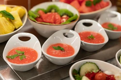 a bunch of bowls of food on a table at Petit Palace Puerta del Sol in Madrid